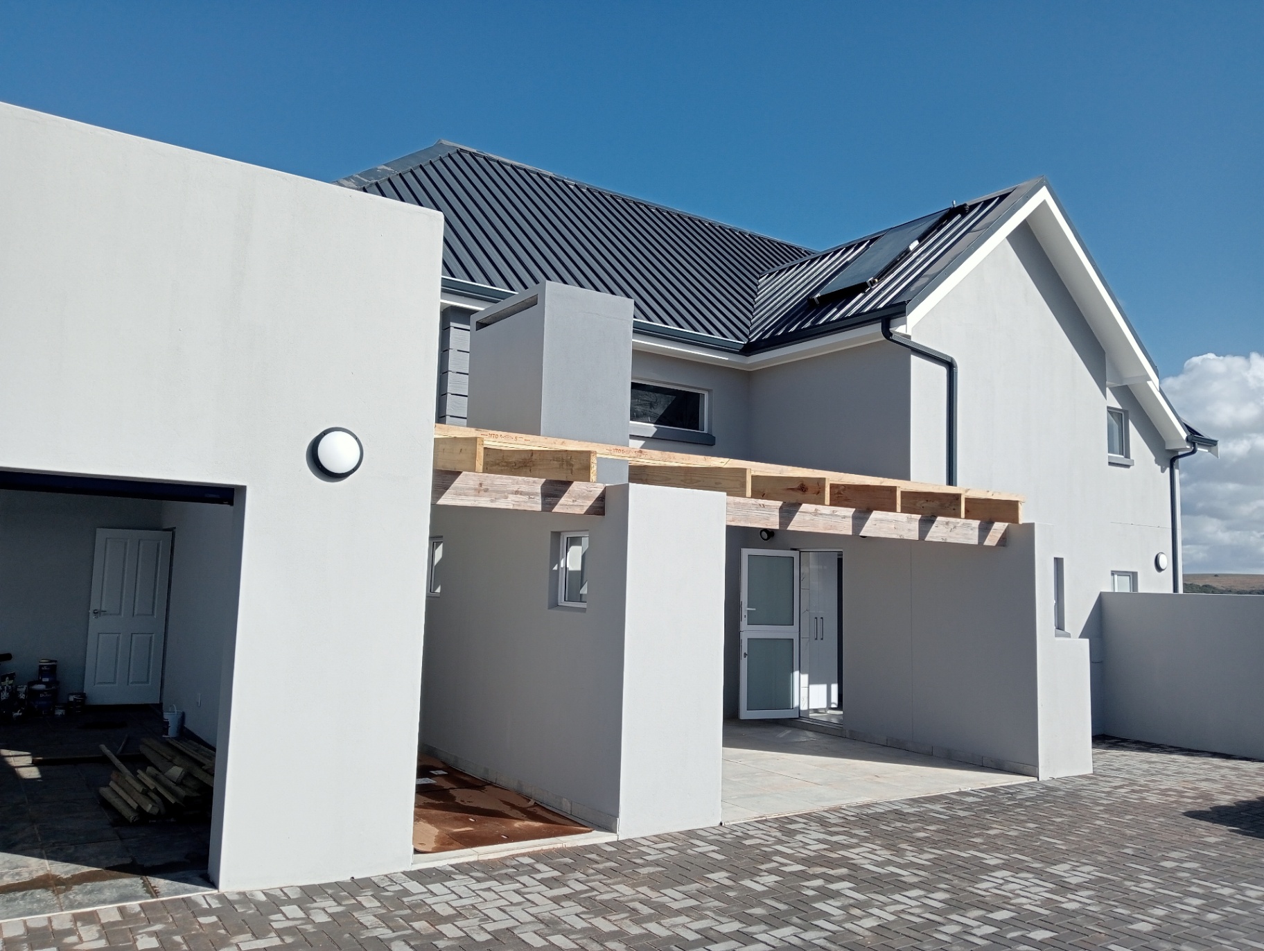 Completed modern home exterior with paved driveway