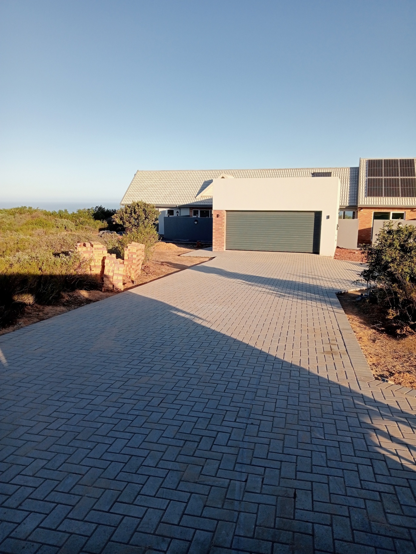 Paved driveway leading to completed garage