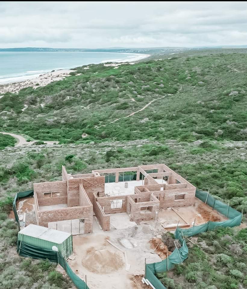 Aerial view of brick home under construction near the coast