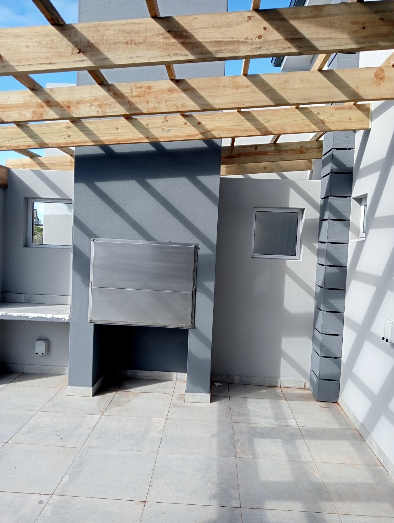 Outdoor braai area with timber pergola