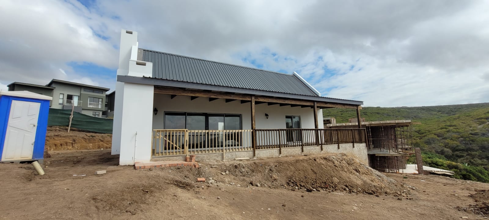 Completed home with covered patio and metal roof